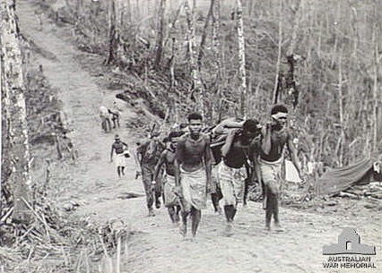 1945 06 27 Natives bringing wounded Pte J. P. Sporn in at Wearnes Hill